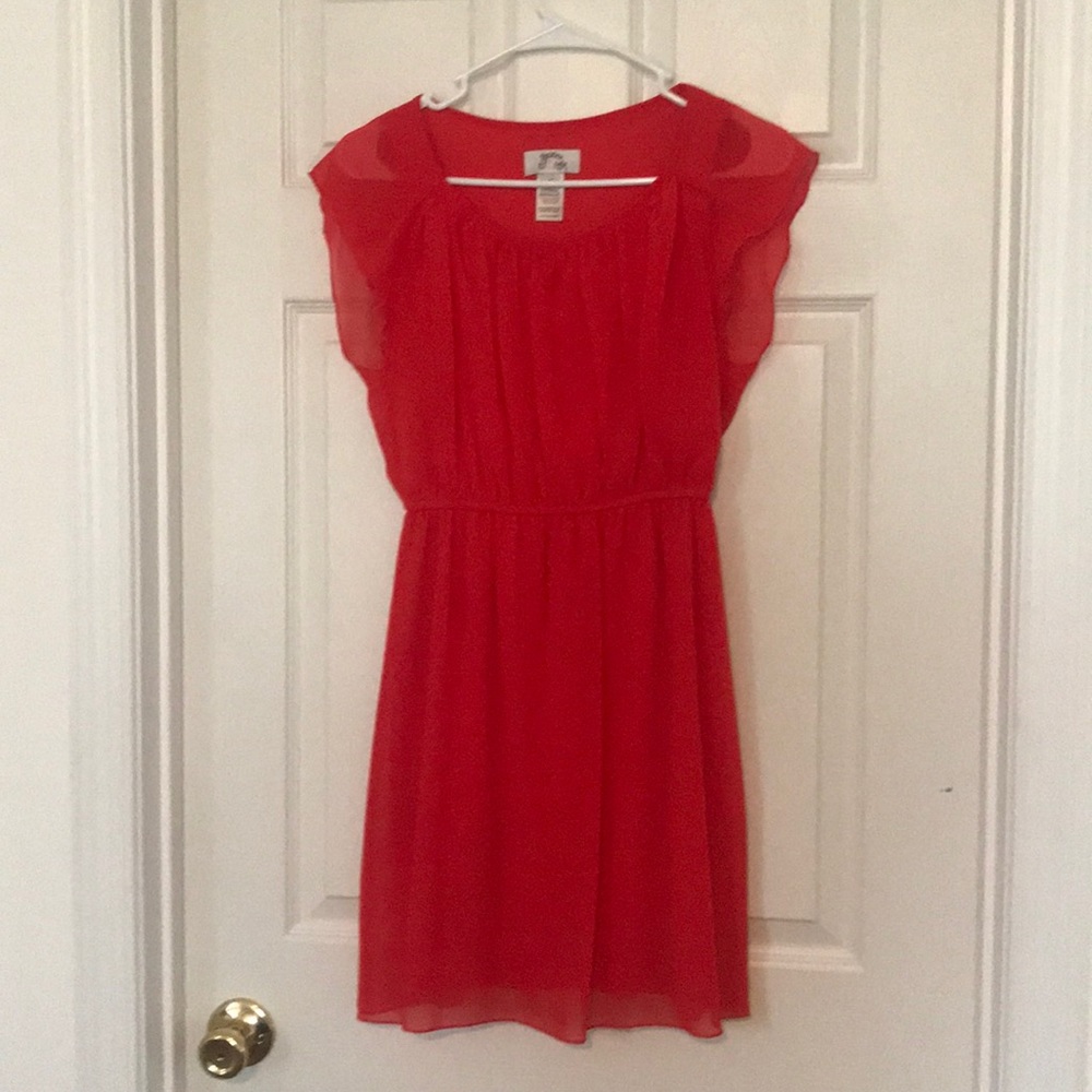 Orange dress with light ruffles.